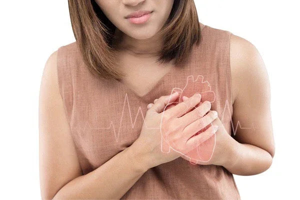 Woman clutching chest with heart graphic, representing heart health or chest pain concern